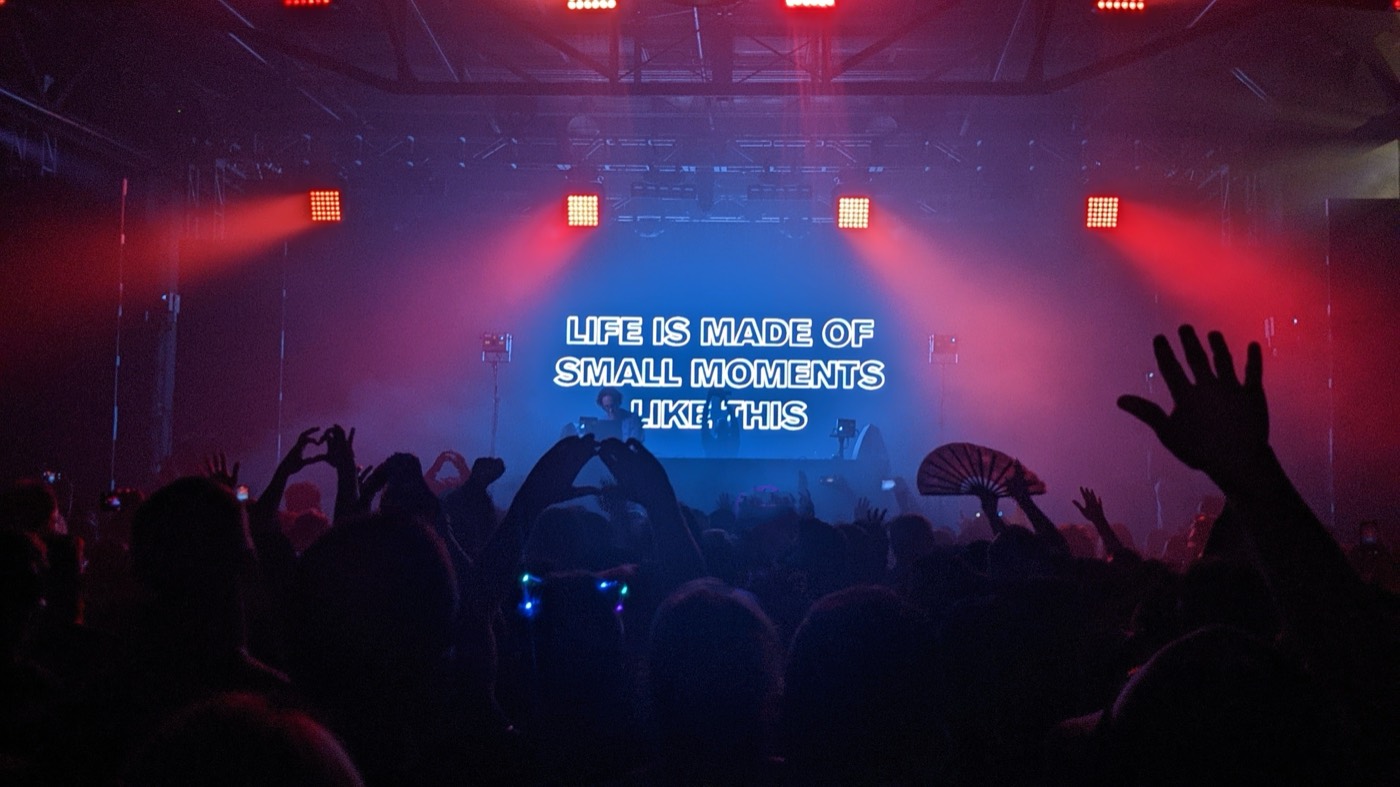 A club floor, stage screen reading life is made of small moments like this